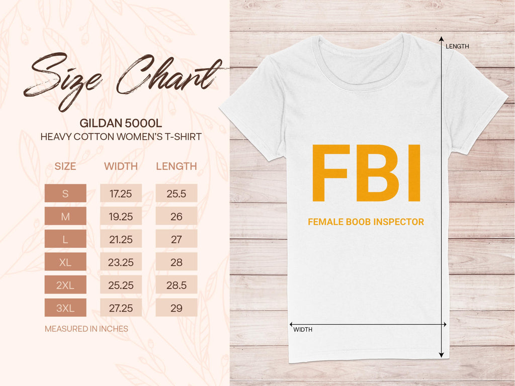 The white FBI Female Boob Inspector T-Shirt by Garment Graphics, ideal as a gag gift, showcases bold orange text. A size chart for womens sizing from Gildan 5000L (S to 3XL) is included on the left. The background features a light wood texture.