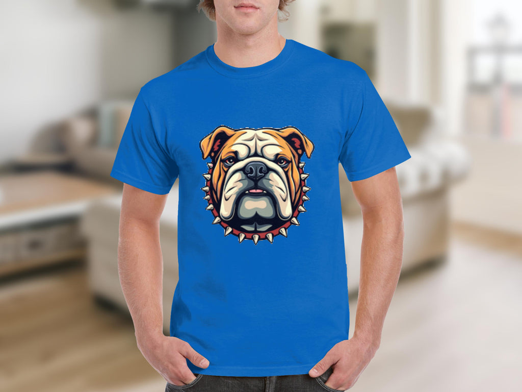 A person is wearing a stylish T-shirt by Garment Graphics, showcasing a cartoon bulldog in orange and white, with a collar featuring red studs. The background is a blurred living room.
