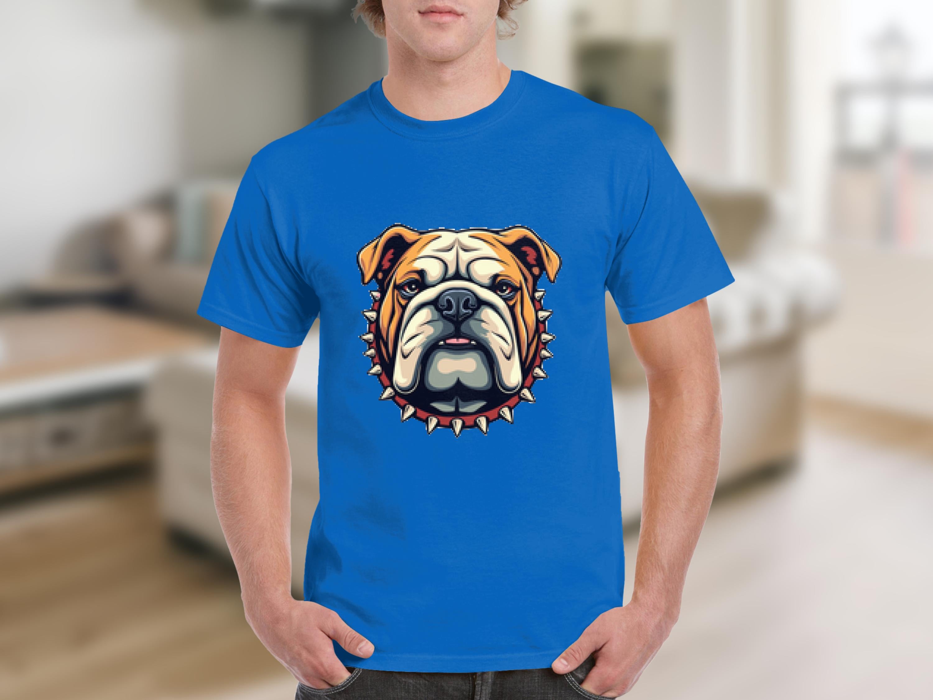 A person is wearing a stylish T-shirt by Garment Graphics, showcasing a cartoon bulldog in orange and white, with a collar featuring red studs. The background is a blurred living room.
