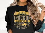 A woman sports a Garment Graphics black sweatshirt with the quirky message: If hes got golf clubs in his truck or a camper in his driveway, I dont hire him. Her long, wavy hair cascades around her shoulders as she playfully twirls a strand.