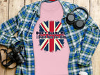 Garment Graphics presents a pink 100% cotton T-shirt featuring a distressed Union Jack and the text Dont Blame Me, I Didnt Vote For Him, artfully displayed on wood with a blue plaid shirt, headphones, camera, and white cup.