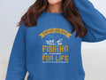 A person is wearing a blue sweatshirt from Garment Graphics that features a Father and Son Fishing Partners for Life slogan, along with an illustration of a boat and fish.