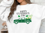 Someone is sporting a festive white Garment Graphics sweatshirt with a green truck and shamrocks. The words Happy St. Patricks Day enhance the cheerful vibe, though their face is not visible.