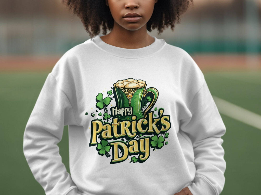 A person outside wears a Garment Graphics white sweatshirt, featuring a festive green mug with frothy beer and shamrocks. Happy Patricks Day is displayed in a playful font, making it perfect for the celebration.