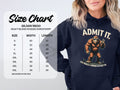 A person sports a Garment Graphics classic fit hoodie showcasing Bigfoot with the text ADMIT IT. LIFE WOULD BE BORING WITHOUT ME. A Gildan 18500 size chart on the left details sizes, widths, and lengths in inches.