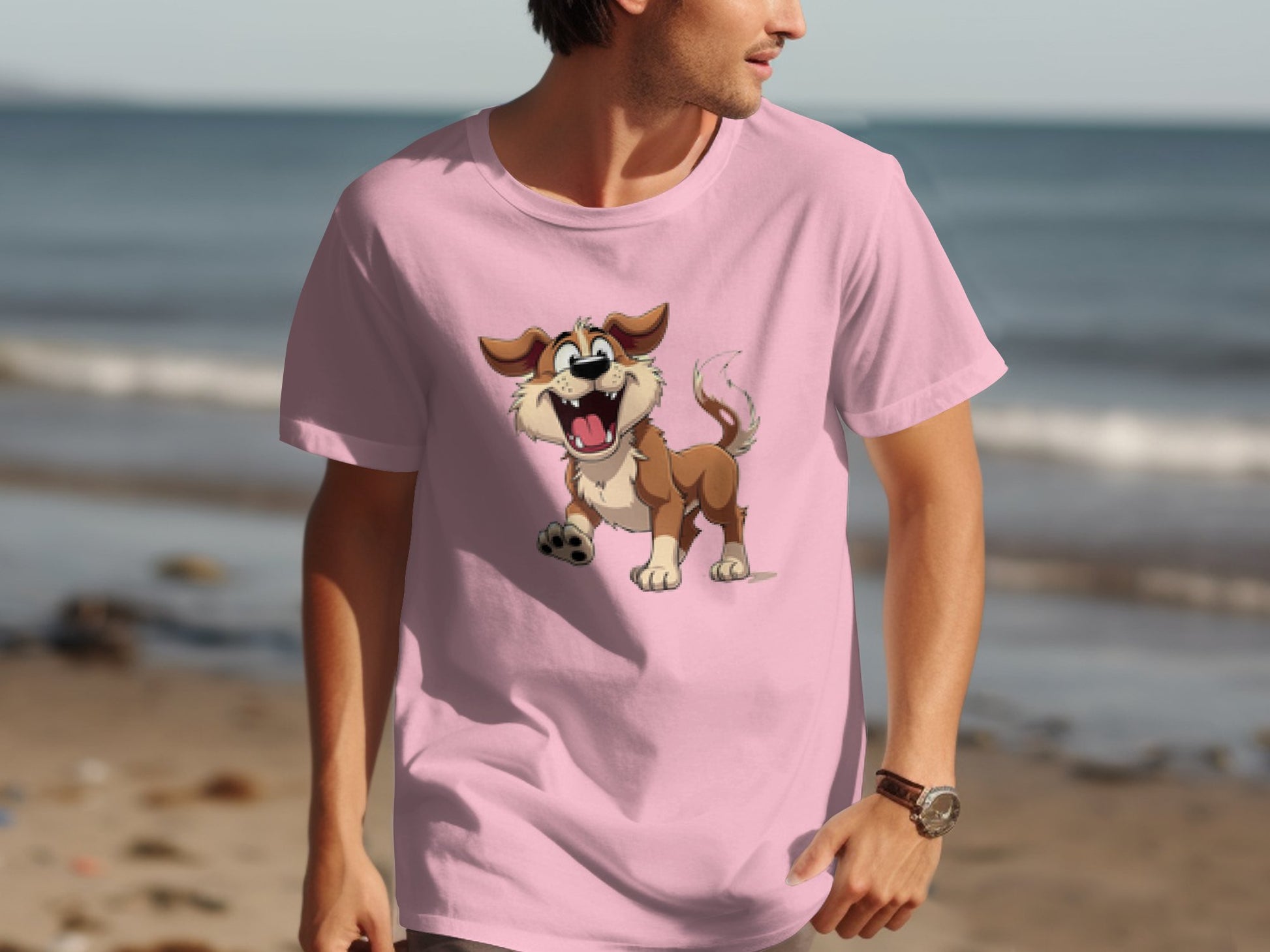 A man wearing a Garment Graphics pink T-shirt with a cartoon dog holding a ball strolls along the beach, enjoying the ocean backdrop—perfect for dog lovers who appreciate the cheerful animated pup.