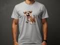 A dog lover wears a light gray T-shirt from Garment Graphics featuring a cartoon dog with brown and white fur, joyfully standing with its tongue out on a neutral dark gray background.