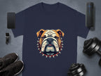 Garment Graphics presents a stylish dark blue T-shirt showcasing a bulldog with a spiked collar. Surrounding items include: smartphone, smartwatch, wireless speaker, black sneakers, adjustable dumbbells on grey background. Perfect for family sizing to match everyone in style.