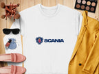 A white Scania logo sweatshirt by Garment Graphics, ideal for casual outings, is displayed on a wooden surface alongside a yellow jacket, pink shoes, sunglasses, makeup brushes, an eyeshadow palette, nail polish, and a small blue pouch. Unisex sizing offers effortless style daily.