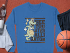 Garment Graphics offers a unisex sweatshirt featuring a cartoon alligator with a basketball and the phrase See You Later Alligator. Its pictured with a water bottle, light gray towel, black shorts, and basketball on an orange surface.
