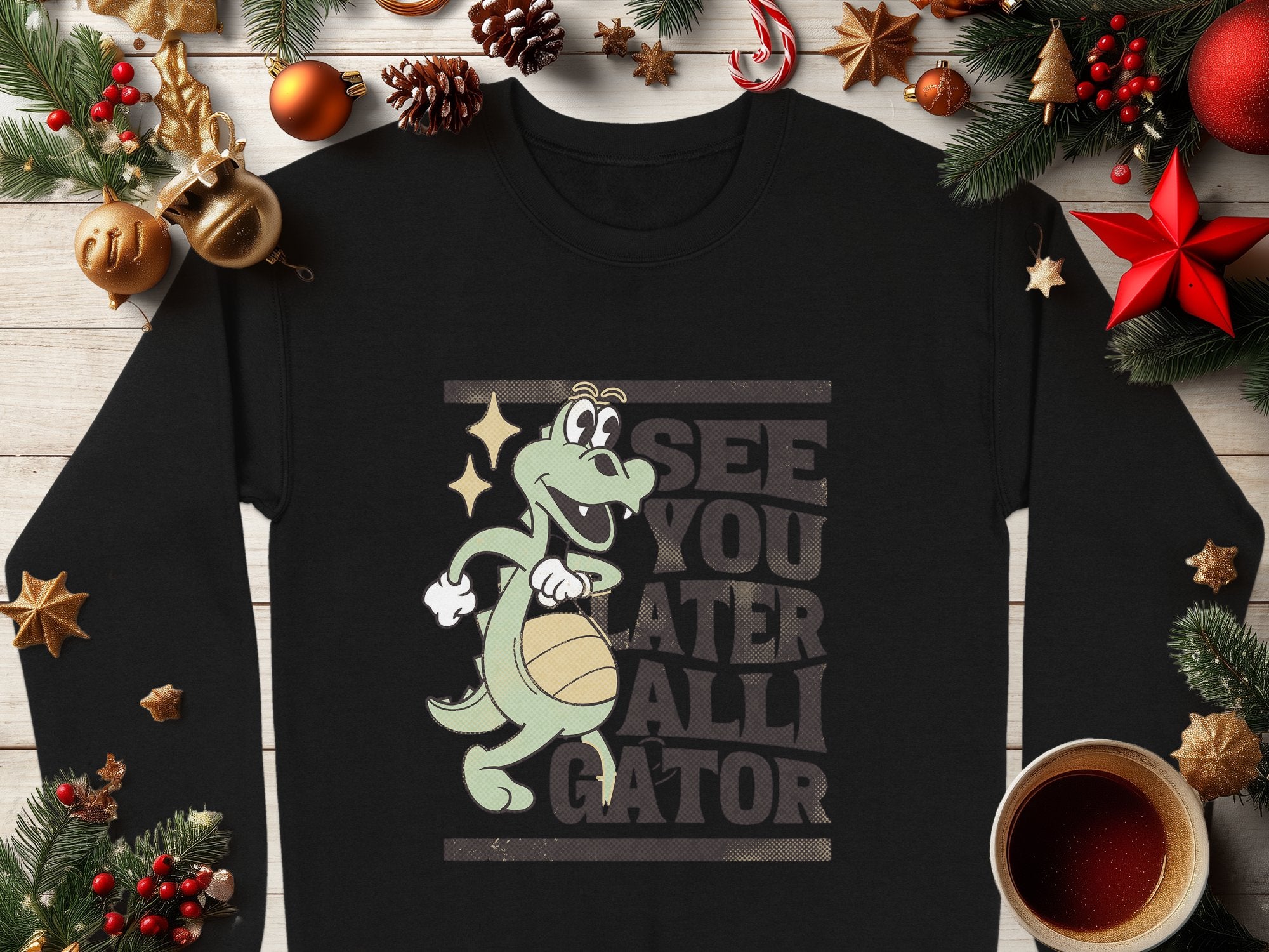 Garment Graphics presents a playful black sweatshirt with an alligator spinning a basketball and the phrase SEE YOU LATER ALLIGATOR, adorned with Christmas ornaments and pine branches on wood.