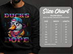 Wearing a black Garment Graphics sweatshirt, adorned with a cartoon duck sporting glasses, cap, and scarf, surrounded by Ducks Dope. Beside it is the Gildan 18000 size chart for unisex sizes S to 5XL. These sweatshirts boast cool swag and are made from medium-heavy fabric.