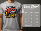 A person is wearing a Garment Graphics Its a Good Day to Laugh t-shirt, adorned with a cheerful message in vibrant colors. Next to them is the Gildan 5000 heavy cotton size chart, showing sizes S to 5XL with width and length in inches.