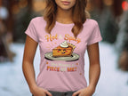 A woman wears a pink Garment Graphics T-shirt with a cartoon spicy pie and texts Hot & Spicy and You Wanna a Piece of Me?. The soft-focus snowy tree backdrop makes it ideal for casual outings.