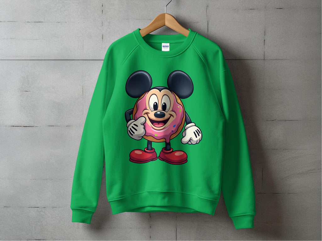 A quirky Garment Graphics sweatshirt hangs on a wooden hanger against a concrete wall, featuring a playful cartoon donut character with large black ears, red shoes, white gloves, and a doughnut body topped with pink icing.