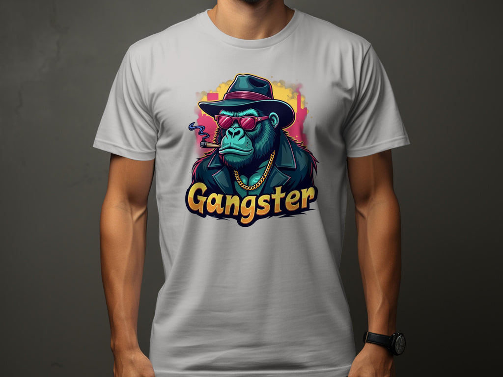 A person is sporting a white Garment Graphics Gangster Gorilla T-Shirt with urban style. This classic fit tee displays a gorilla dressed as a gangster—complete with hat, sunglasses, coat, gold chain, and smoking cigar. The word Gangster stands boldly beneath the illustration.