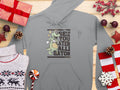 The Garment Graphics classic fit gray hoodie showcases a cartoon green alligator holding a basketball and the text See You Later Alligator. Nestled among a cozy sweater, candies, decorations, and gifts on wood, its ideal for gator graphic fans!.