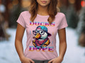 A person in a light pink Garment Graphics T-shirt showcases the Cool Brave Wild Swag Duck design, complete with glasses and hat, framed by Ducks Dope, all set against a blurred outdoor background.