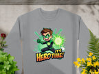The Garment Graphics gray sweatshirt showcases a cartoon superhero with brown hair in a green suit, emitting green energy. The text Its Hero Time! is below. Decorated with vibrant plants and flowers, this unisex piece is perfect for fans of the genre.