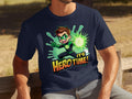 A person relaxes on a wooden bench outdoors, wearing a vibrant dark blue Garment Graphics T-shirt with a superhero graphic featuring a cartoon superhero in green and black and glowing text reading Its Hero Time!.