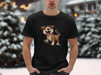 A dog lover stands outside wearing a black Garment Graphics T-shirt adorned with an animated cartoon dog, surrounded by snow-covered trees and blurred lights, capturing winters magical essence.
