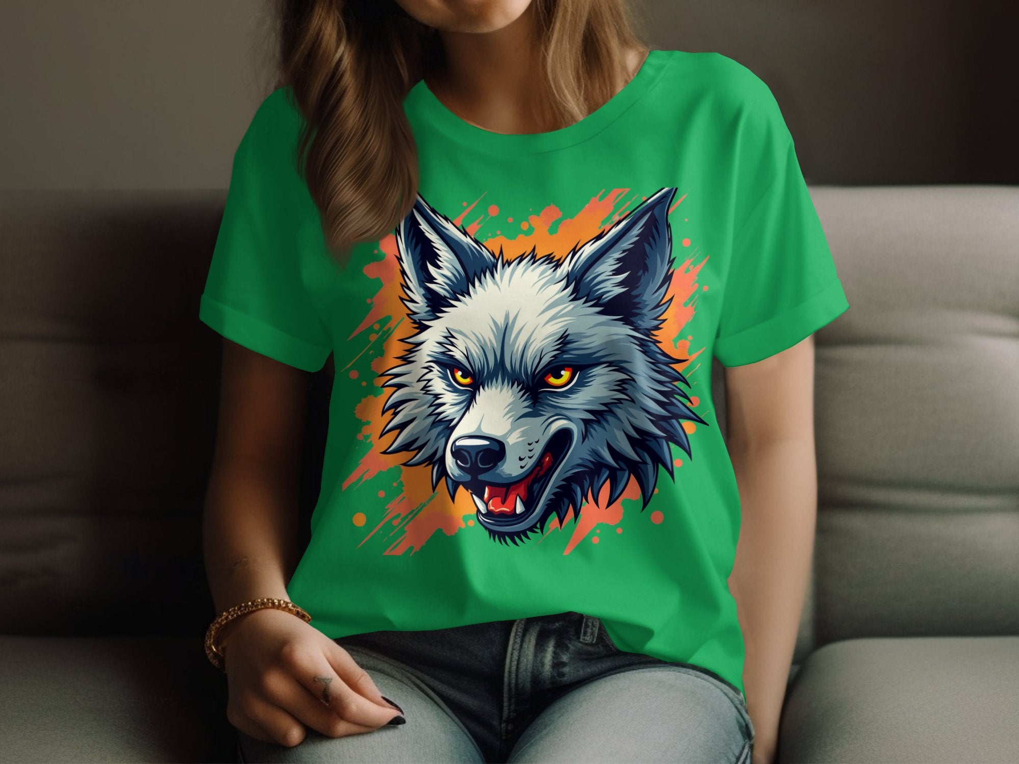 A person relaxes on a couch wearing Garment Graphics bold green T-shirt, crafted from 100% cotton, showcasing a fierce wolfs head with sharp teeth and piercing yellow eyes against an orange splatter background—ideal for expressing a daring personality.