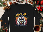 The Garment Graphics black Bulldog Sweatshirt features a bulldog with a gold chain and crown under CITY KING graffiti. Set among holiday decorations and a steaming coffee on wood, it exudes urban royalty with seasonal flair.