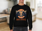 A person is wearing a Garment Graphics black sweatshirt with a bull illustration. It features two bulls facing forward against an orange circle and the word BULLOCKS in bold orange letters, set against the ambiance of a blurred room.