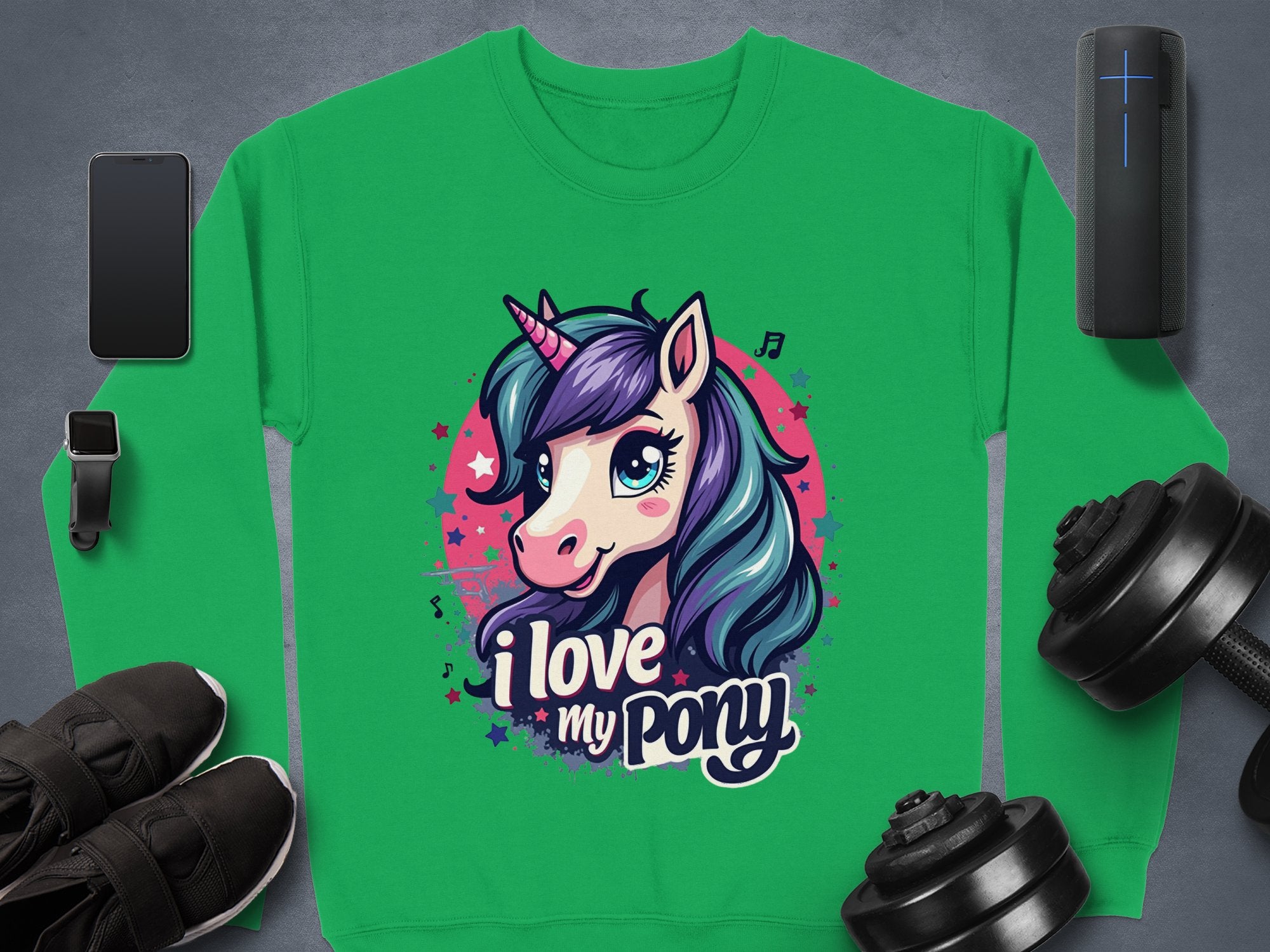 A Garment Graphics green sweatshirt showcases a ponyunicorn graphic with I love my pony text. It has a purple-maned, cheerful unicorn surrounded by icons of a smartphone, smartwatch, sneakers, wireless speaker, dumbbells, and a cylindrical device.