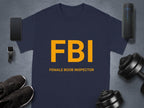 A navy blue Female Boob Inspector T-shirt by Garment Graphics flaunts bold yellow FBI letters and pairs hilariously with a smartphone, fitness tracker, black shoes, dumbbells, and a portable speaker—ideal for fans of funny designs.