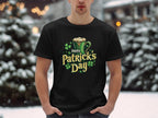 Amid snowy surroundings, someone makes a bold statement wearing a Garment Graphics black T-shirt decorated with frothy beer and clovers. The shirt proudly displays Happy Patricks Day in vibrant green and white text, perfectly capturing the festive spirit.