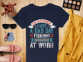 A Garment Graphics navy fishing T-shirt reads Id rather have a bad day fishing than a good day at work. Its artfully displayed with makeup, pink shoes, a yellow blazer, and a light blue purse, ideal for fishing enthusiasts in womens sizing.