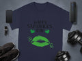 A navy blue Garment Graphics T-shirt showcases Happy St. Patricks Day with green lips and clovers. Nearby are a smartphone, smartwatch, wireless speaker, black shoes, and adjustable dumbbells.