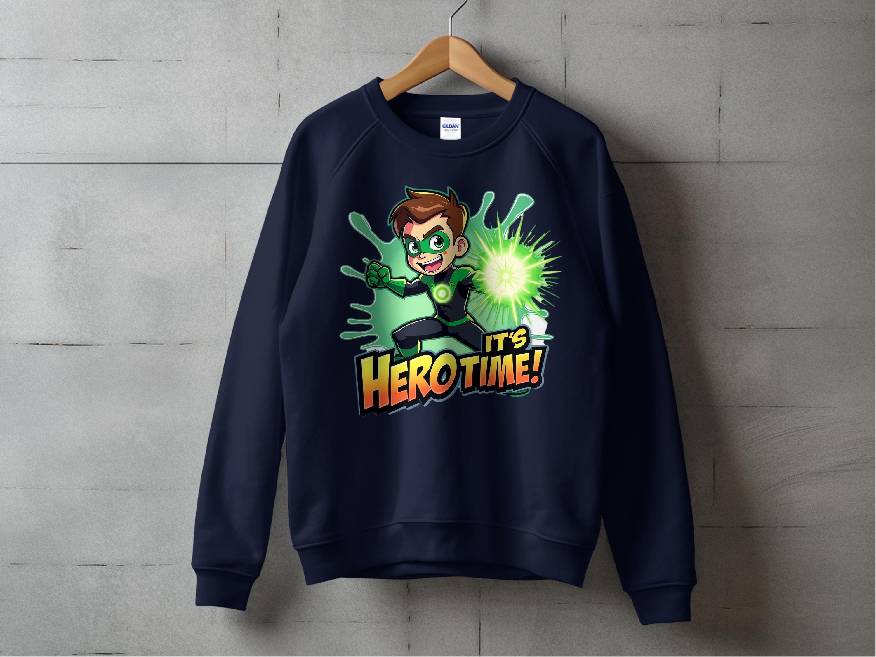 A dark blue Its Hero Time! graphic sweatshirt by Garment Graphics hangs on a wooden hanger against a concrete wall, featuring a spiky-haired cartoon character in green, radiating energy and capturing the adventurous spirit of youth.