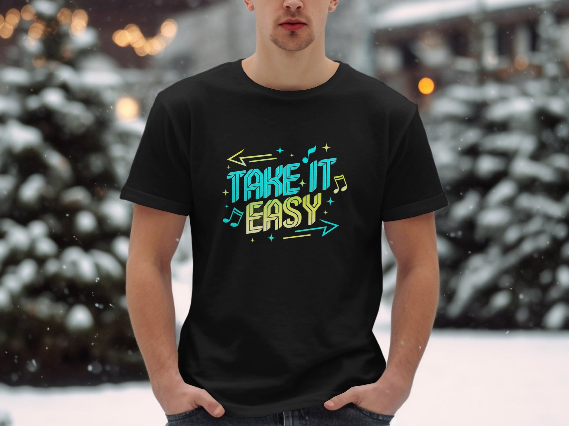 Amidst snowy surroundings, a person wears a Garment Graphics black t-shirt featuring Take It Easy in colorful designs. Snow-covered trees adorn the background, with warm twinkling lights resembling musical notes creating a serene melody.