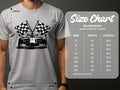 A person in a gray Garment Graphics T-shirt with a race car and two checkered flags embodies motorsport excitement. The size chart for the Gildan 5000 T-shirt shows sizes S-5XL with width and length measurements in inches.