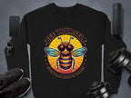 Garment Graphics black unisex sweatshirt, from the Summer Edition, showcases a vibrant bee in sunglasses with the text Bee Yourself Everyone Else Is Taken, set amidst gadgets and gear on a gray background.