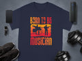 Garment Graphics offers a navy blue Born To Be Musician T-shirt for music lovers featuring distressed text with drummer and guitarist silhouettes against an orange-yellow gradient. Its ideal alongside fitness gear and tech gadgets.
