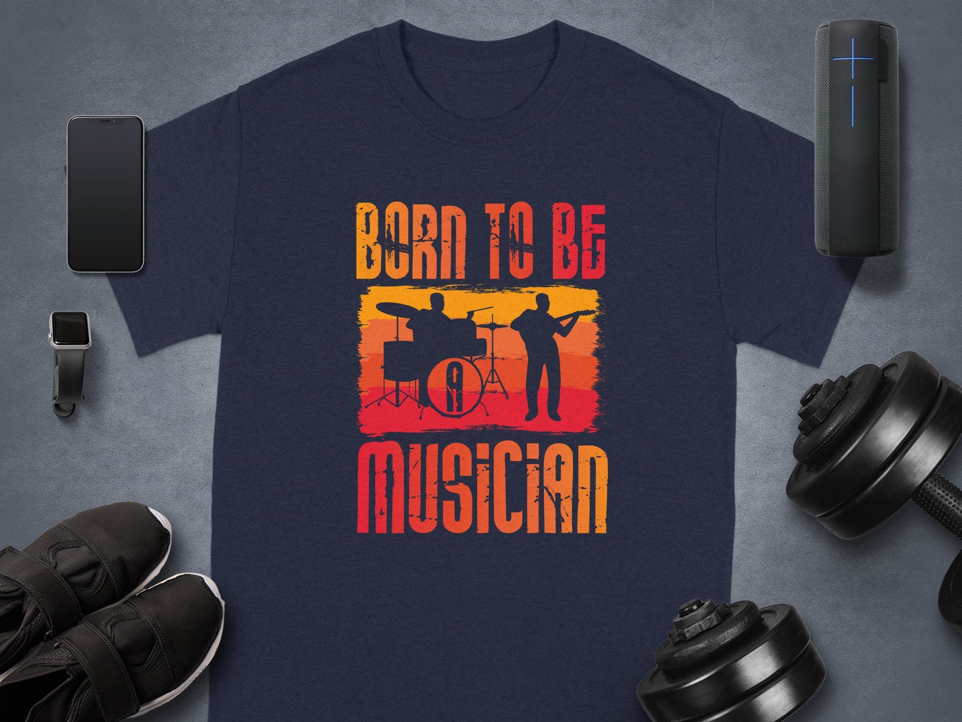 Garment Graphics offers a navy blue Born To Be Musician T-shirt for music lovers featuring distressed text with drummer and guitarist silhouettes against an orange-yellow gradient. Its ideal alongside fitness gear and tech gadgets.