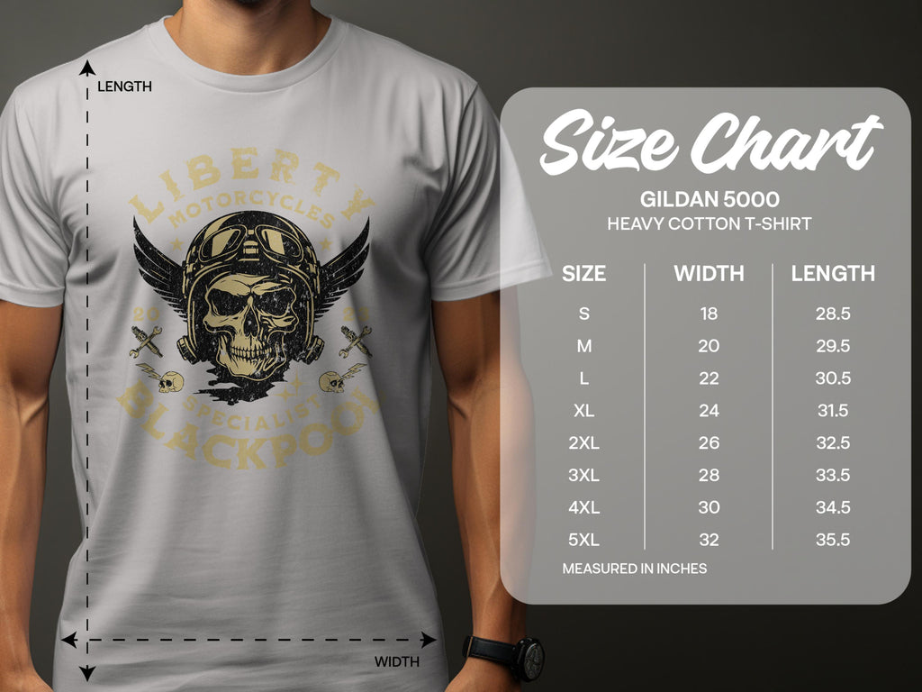 A person in a gray Garment Graphics t-shirt with a skull and wings design perfect for motorcycle enthusiasts, reading Liberty Motorcycles Specialists Blackpool. A Gildan 5000 Heavy Cotton T-Shirt size chart from small to 5XL with inch dimensions is on the right.