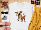 Garment Graphics white sweatshirt showcases a cheerful animated dog, surrounded by fashion items like a yellow jacket, makeup palette, sunglasses, pink shoes, brushes, lipstick, and a blue pouch on a wooden surface—a stylish choice for dog lovers!.