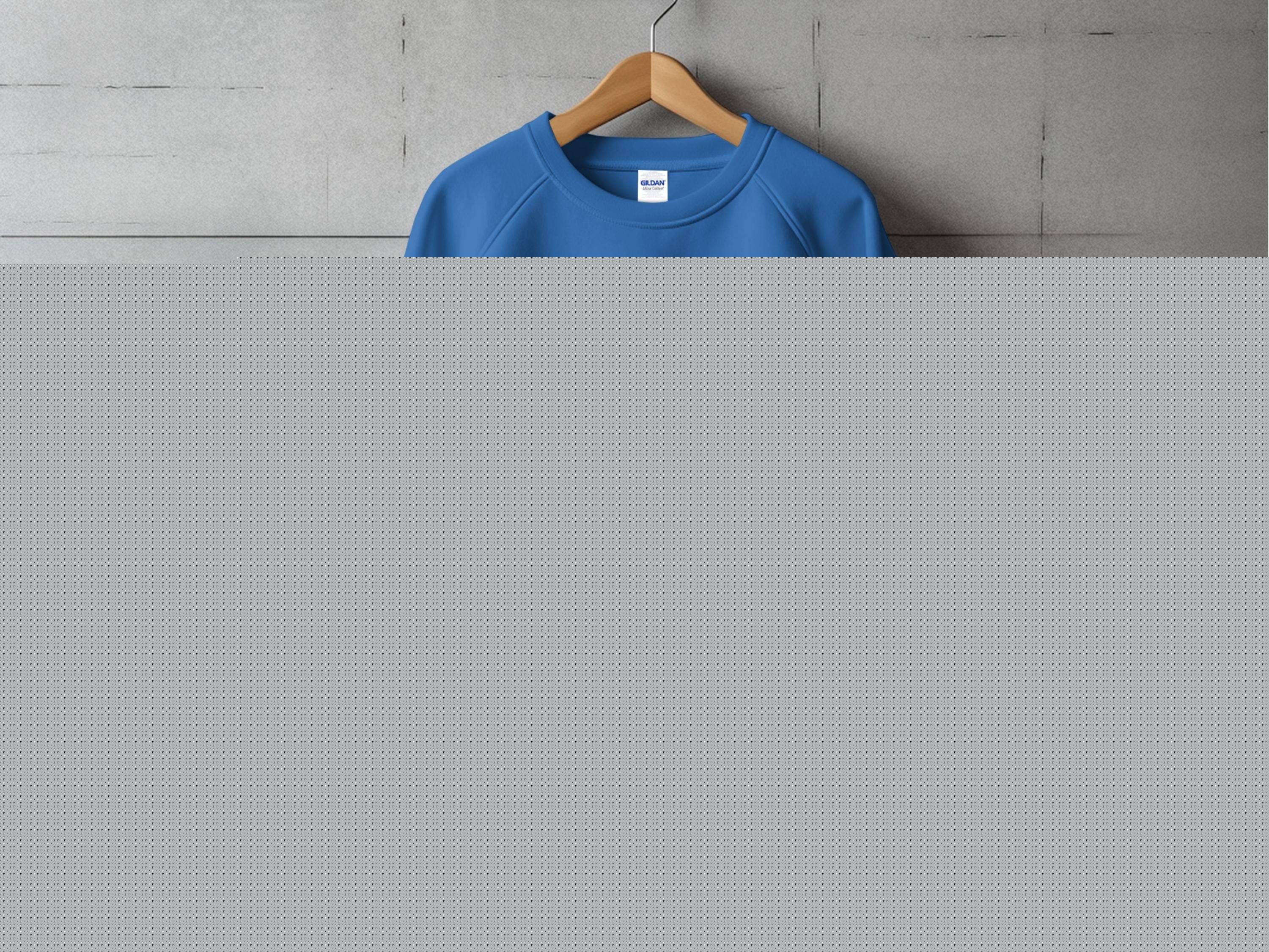 Displayed on a wooden hanger against a gray background, the blue Garment Graphics sweatshirt features a festive beer mug graphic with shamrocks and the text Happy Patricks Day, perfectly capturing the spirit of St. Patricks Day.