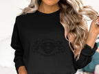 A person with long, wavy blonde hair is wearing a stylish black sweater by Garment Graphics, showcasing a cool Scania Power design and the number 8. They are holding a strand of their hair in one hand.