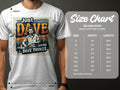 A person is wearing a Garment Graphics white graphic T-shirt, classic fit, featuring a mans image and Just Dave Doing Dave Things text. Next to them is the Gildan 5000 heavy cotton size chart, listing sizes S to 5XL with measurements.