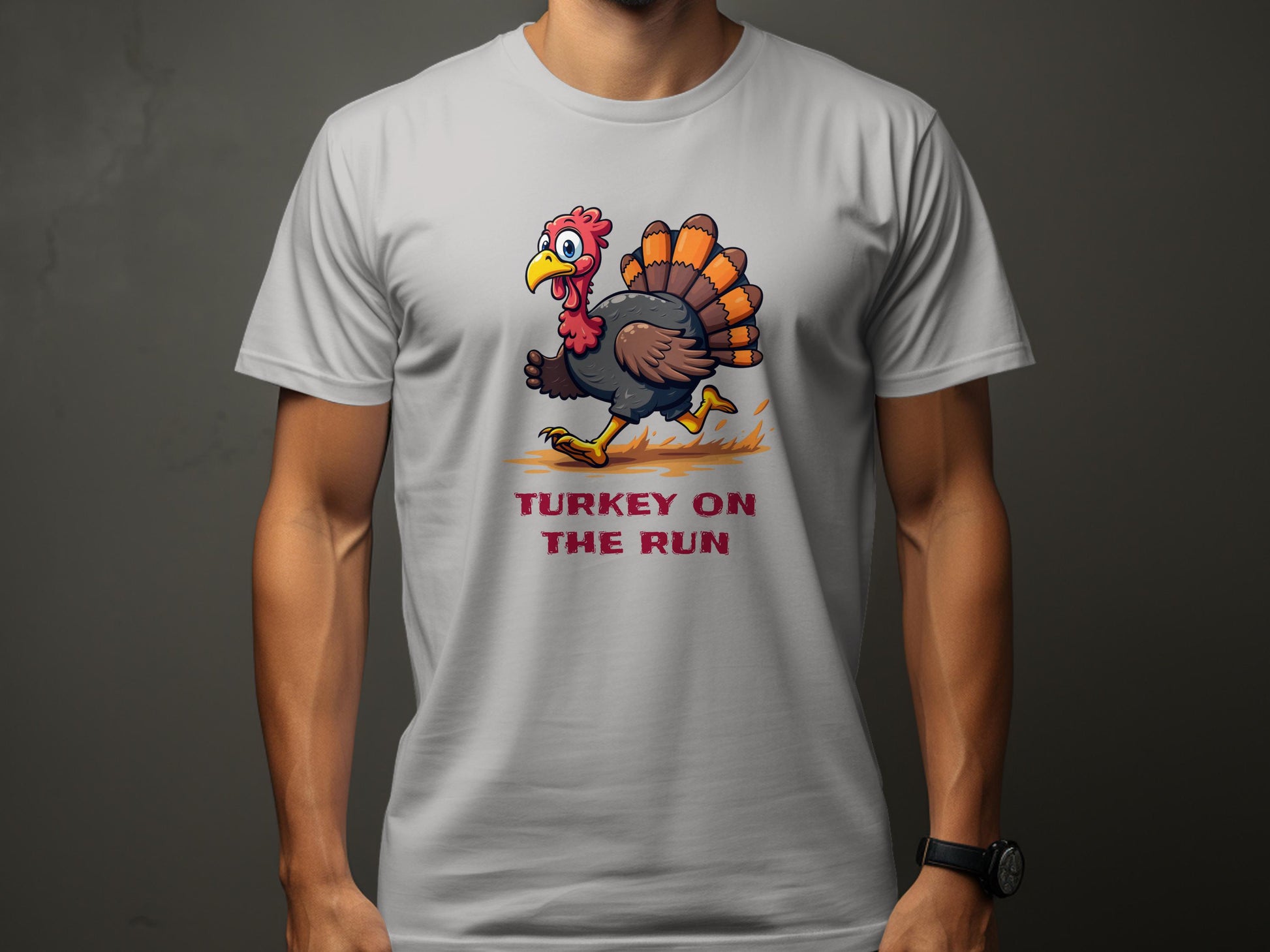 A person is wearing a Garment Graphics light gray graphic T-shirt featuring a bright cartoon turkey sprinting, with TURKEY ON THE RUN below. Its classic fit offers comfort and style on the muted background.
