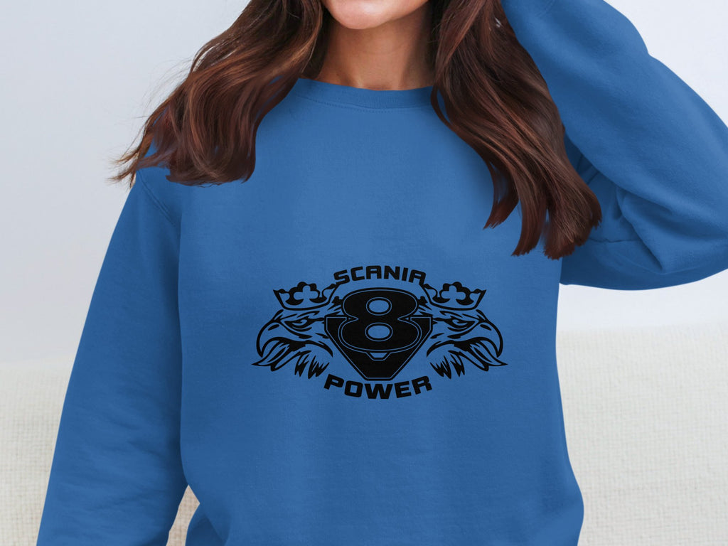 A person wearing a blue Garment Graphics sweatshirt featuring a Scania Power logo with a black number 8 and stylish design; their face is cropped out, focusing on the Scania Power V8 apparels trendy vibe.