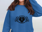 A person wearing a blue Garment Graphics sweatshirt featuring a Scania Power logo with a black number 8 and stylish design; their face is cropped out, focusing on the Scania Power V8 apparels trendy vibe.