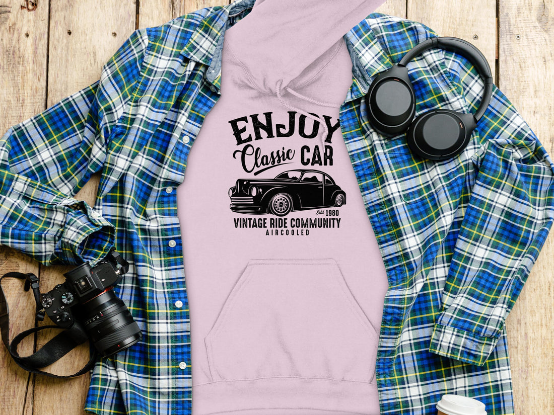 Wearing a Garment Graphics black hoodie, theres Enjoy Classic Car above a vintage car image and Vintage Ride Community Aircooled below, reflecting community spirit. The classic fit stands out against the plain white background.
