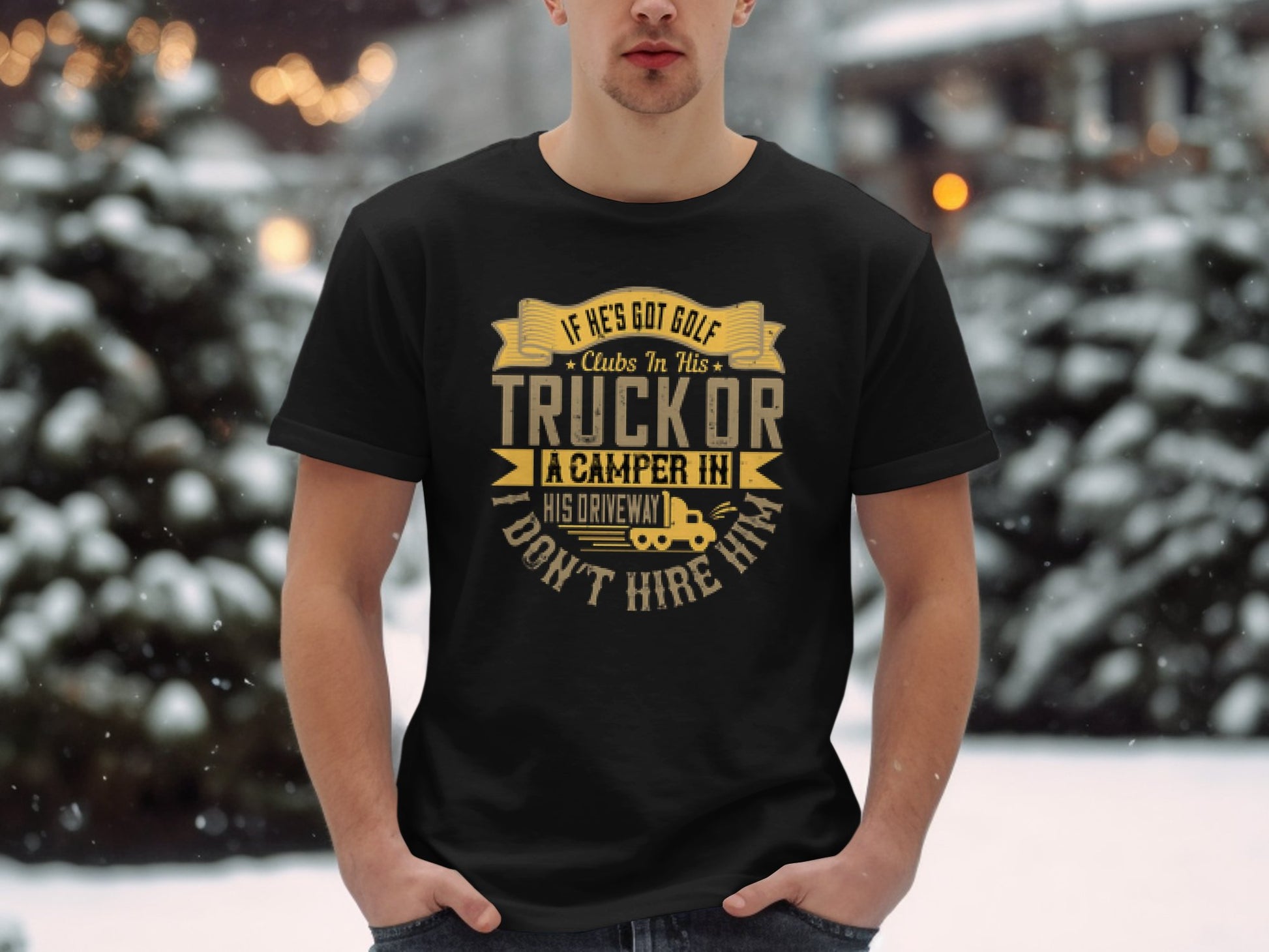 Standing in snowy surroundings, a person wears a black Garment Graphics t-shirt featuring a humorous phrase about golf and camping against a blurred background of trees and soft lights.