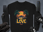 Garment Graphics black sweatshirt from the One Love Sweatshirts collection features a tropical sunset with palm trees, an airplane, and mountains. Unisex sizing ensures a perfect fit for all. Displayed with smartphone, smartwatch, earbuds, athletic shoes, and dumbbells on a gray surface.